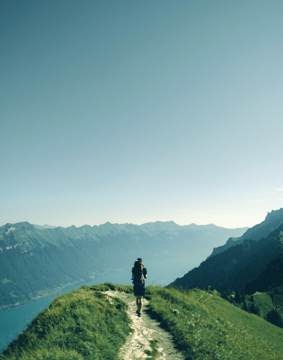 A man is walking on the top of a mountain