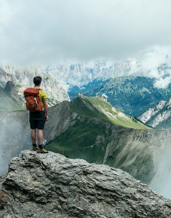 A man is walking on the top of a mountain